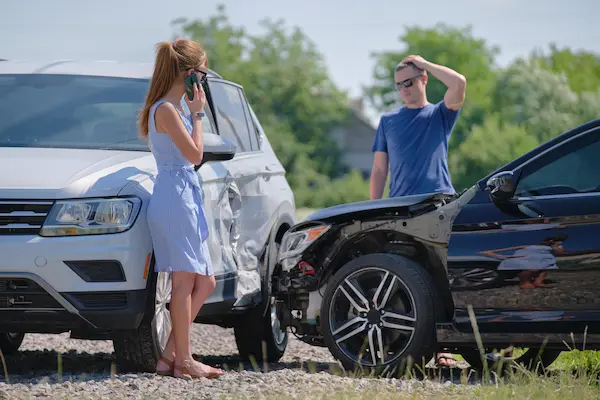 Two people discuss their next steps after a car accident.