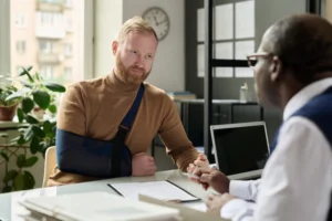 Atlanta workers compensation lawyer consulting with injured manufacturing worker about claim