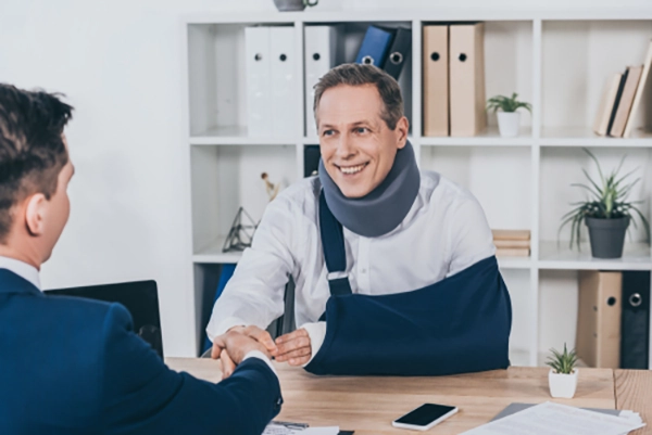 inured worker shaking hand of attorney