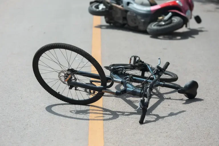 Child injury claims represented by a bicycle and moped in the street.