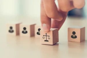 Denied workers' compensation appeal is represented by blocks with law icons, including one with a justice scale and others with businessmen as lawyers.