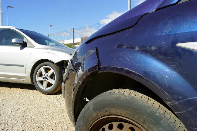 Damaged blue and silver cars after a head-on collision, highlighting the severity of car accidents in Buford, Georgia.