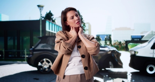 Woman in pain after car accident seeking car accident lawyer in Cumming, GA