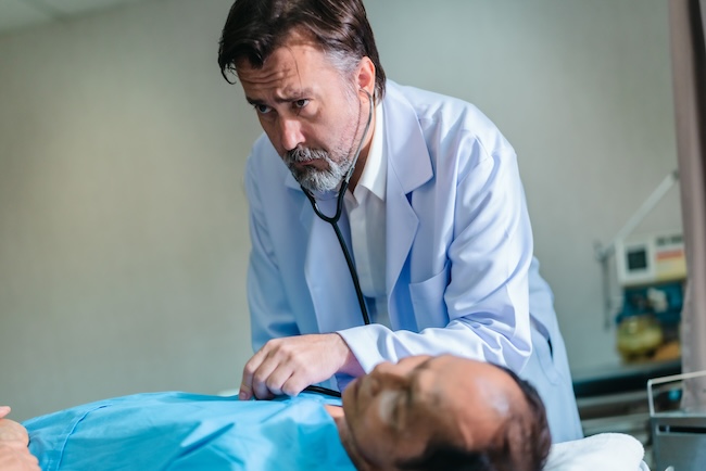 Doctor examining patient for delayed injury symptoms weeks after workplace accident