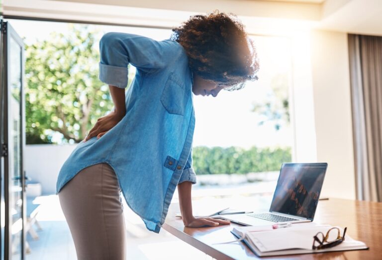 A woman is experiencing back pain at work and requires a premises liability claim for unsafe workplace conditions in South Carolina.