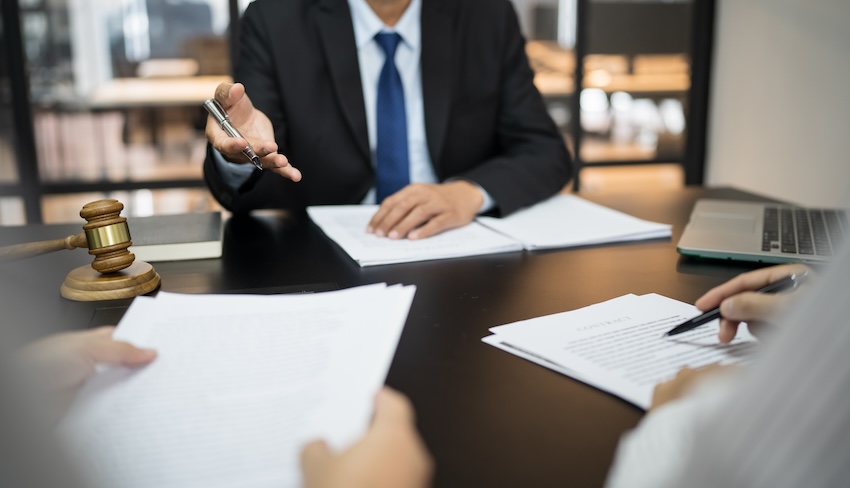 Alpharetta construction workers' compensation lawyer reviewing a North Fulton County job site injury claim with an injured worker during a free case evaluation in Georgia