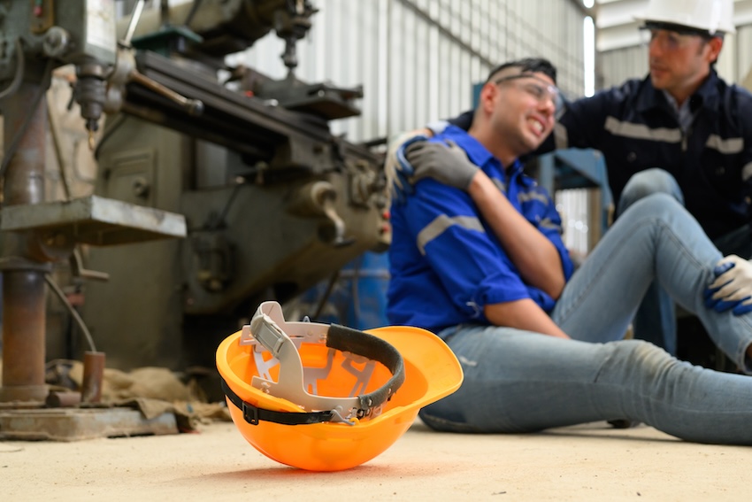 Injured manufacturing worker on factory floor in Atlanta seeking workers compensation benefits