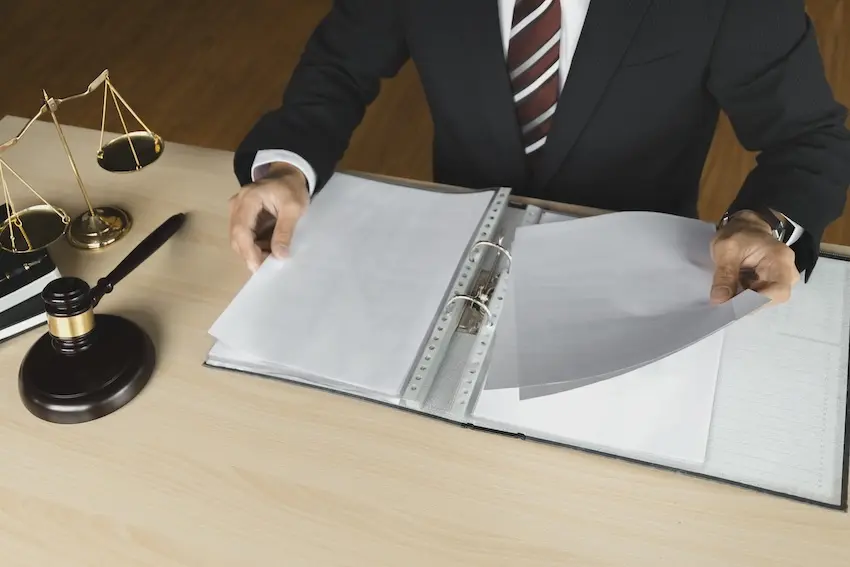 Marietta workers compensation attorney reviewing a manufacturing injury claim file on behalf of an injured Georgia worker