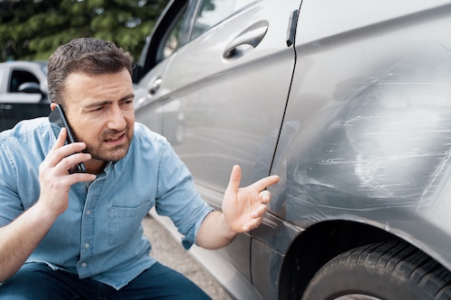 Man On Phone After Car Accident - Report a Car Accident