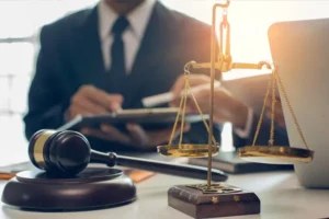 Attorney at his desk with a gavel and scale