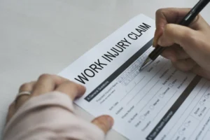 Workers compensation claim form for a poultry plant injury in Georgia with pen ready to sign